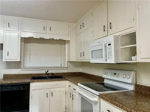 a kitchen with cabinets appliances and a counter space