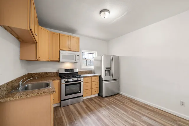 a kitchen with a sink stove and refrigerator
