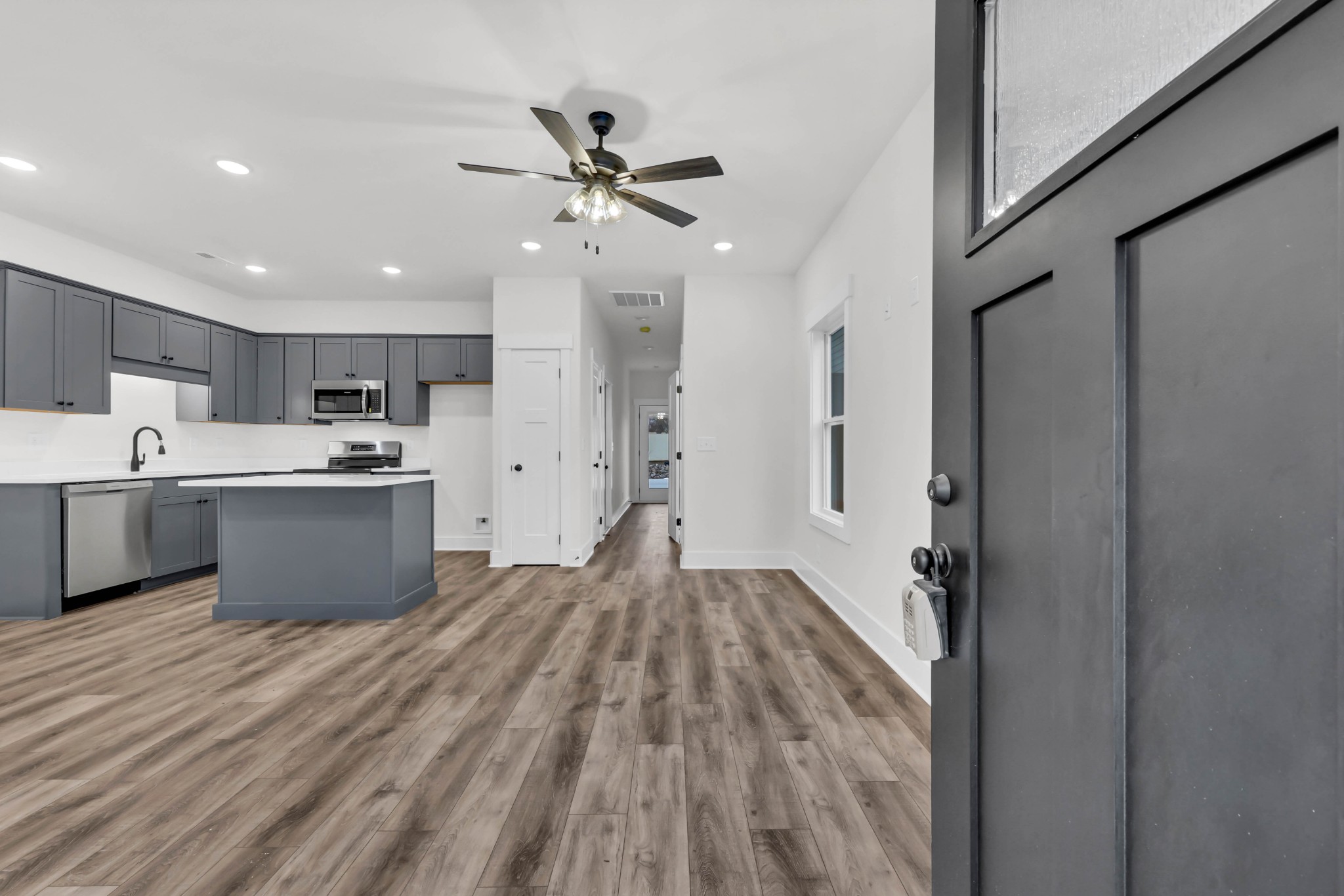 180 Clay Ridge Drive, Unit A4 Clarksville, TN 37040 - Photo 4 of 26 a room with kitchen island a sink and wooden floor