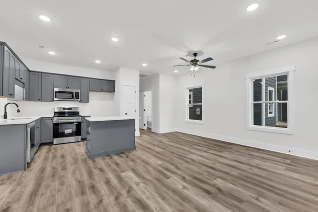 a large kitchen with kitchen island a sink dishwasher stove and refrigerator