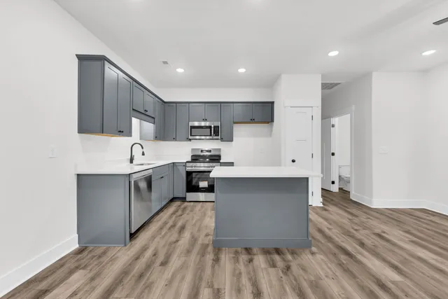 a kitchen with stainless steel appliances a refrigerator sink and cabinets