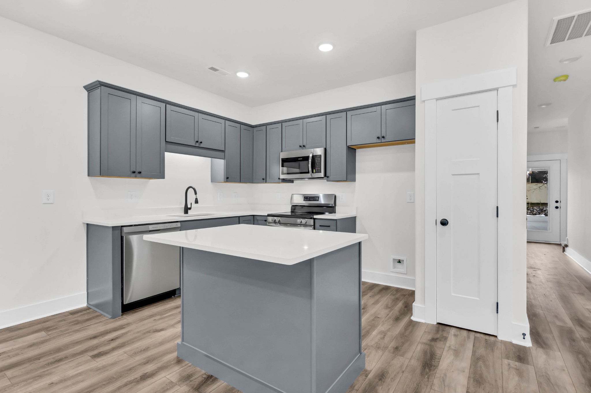 180 Clay Ridge Drive, Unit A4 Clarksville, TN 37040 - Photo 9 of 26 a kitchen with white cabinets and stainless steel appliances