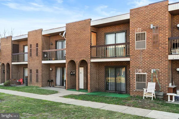 a front view of a brick house with a yard