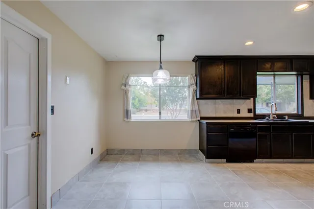 a kitchen with a stove sink and cabinets