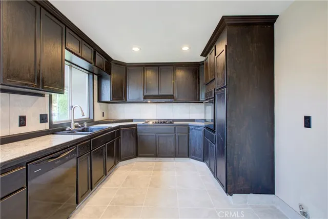 a kitchen with a sink stove and refrigerator
