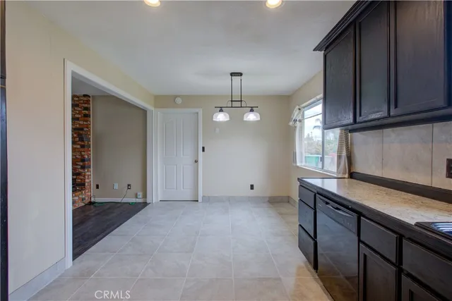 a view of kitchen with granite countertop cabinets and wooden floor