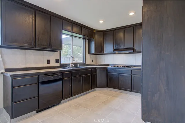 a kitchen with a sink stove and cabinets