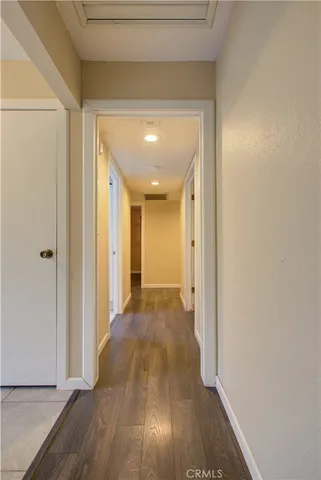 a view of a hallway with wooden floor