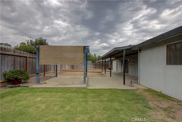 a backyard of a house with table and chairs