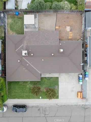 an aerial view of a house with a yard and a sitting area