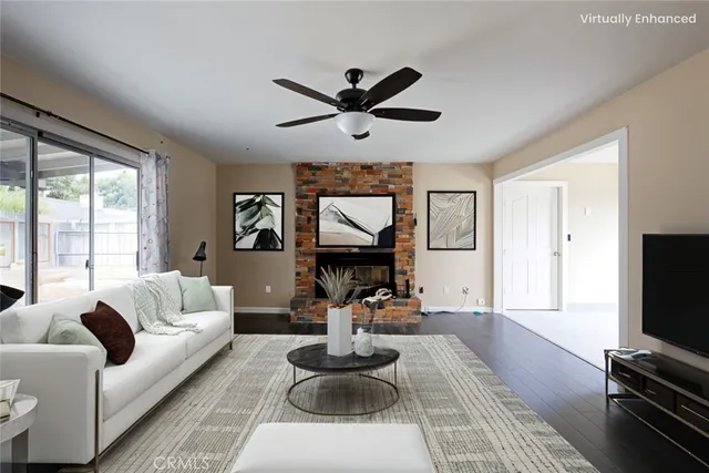 a living room with furniture a flat screen tv and a large window