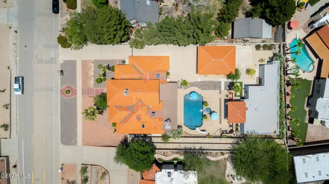 an aerial view of residential houses with outdoor space and parking