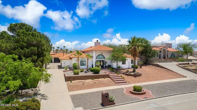 a view of a house with swimming pool and sitting area