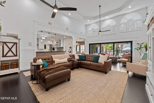 a living room with furniture and kitchen view