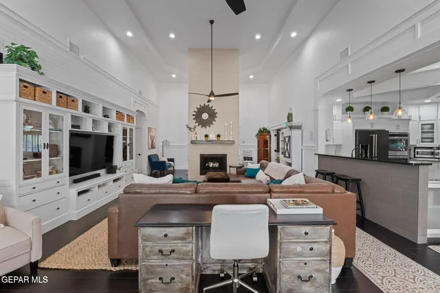 a living room with furniture a flat screen tv and a fireplace