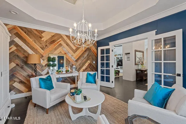 a view of a livingroom with furniture and a chandelier