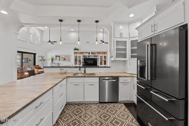 a kitchen with stainless steel appliances a refrigerator sink and cabinets