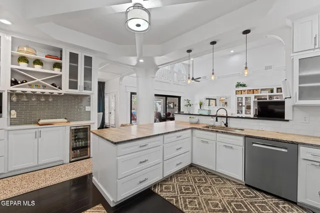 a kitchen with a sink stainless steel appliances and cabinets
