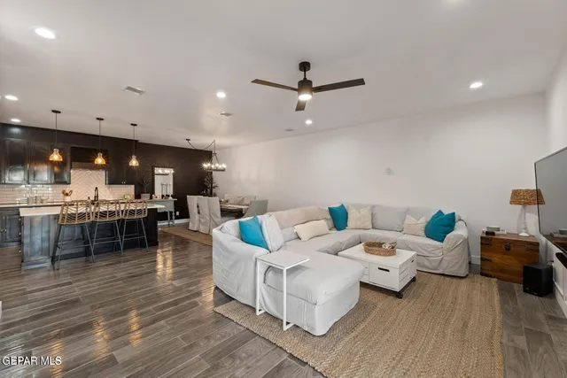 a living room with furniture and kitchen view