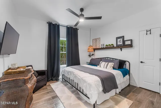 a bedroom with a bed and a flat screen tv