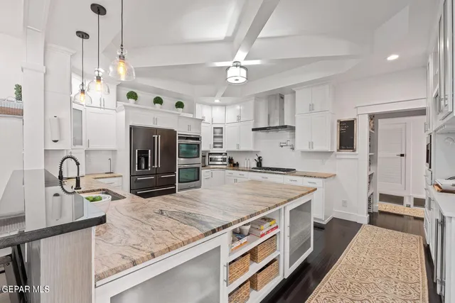 a kitchen with stainless steel appliances granite countertop a sink a stove and a refrigerator