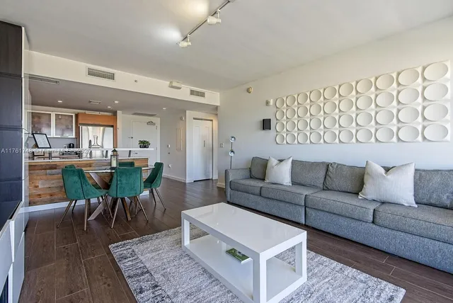 a living room with furniture wooden floor and a table