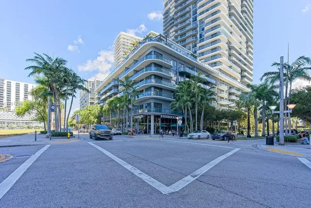a man walking down a street next to a building