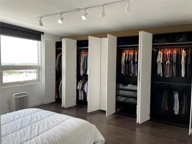 a bedroom with furniture and window