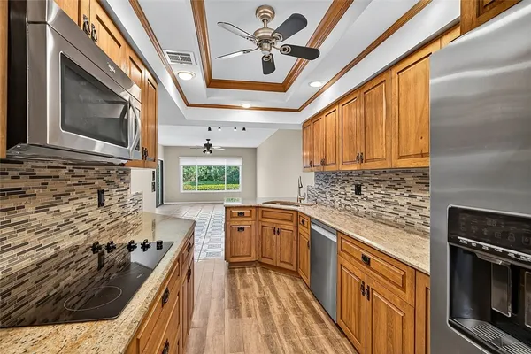 a kitchen with stainless steel appliances granite countertop a stove sink and cabinets