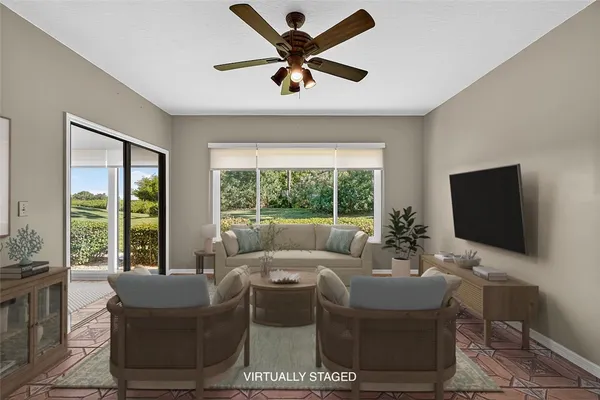 a living room with furniture a large window and a flat screen tv