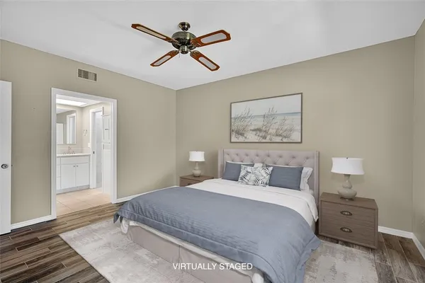 a bedroom with a bed and a painting on the wall