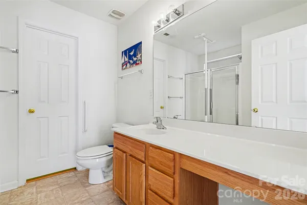 a bathroom with a sink a toilet and shower curtain