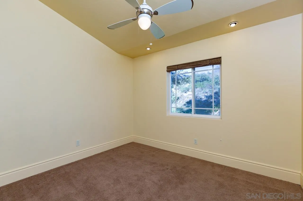 1328 Riverwood Road Santa Ysabel, CA 92070 - Photo 13 of 31 an empty room with a window and a fan