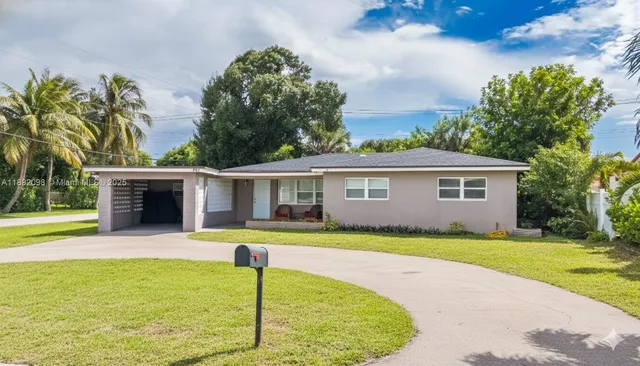 a view of a house with a swimming pool and a yard