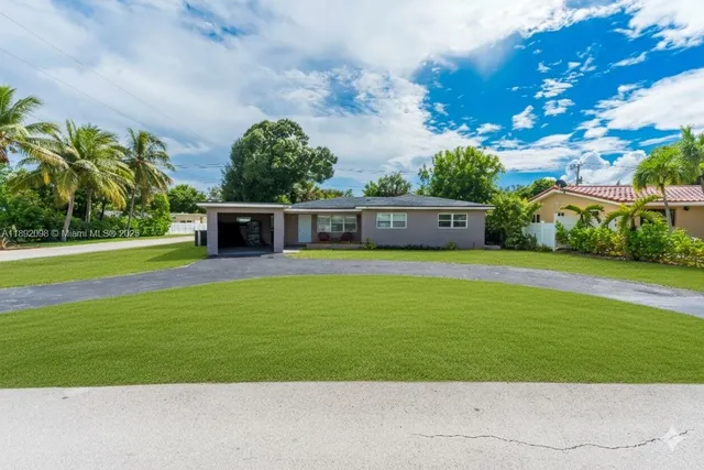 an aerial view of residential house and yard