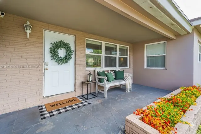 a living room with a couch and a potted plant