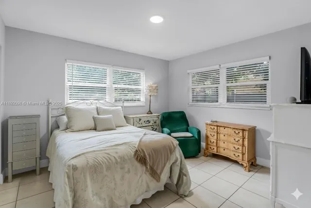 a spacious bedroom with a bed and painting on the wall