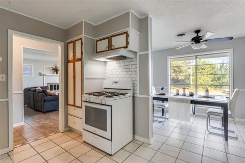 a kitchen with cabinets and chairs