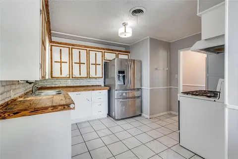 a room with a stove and a refrigerator