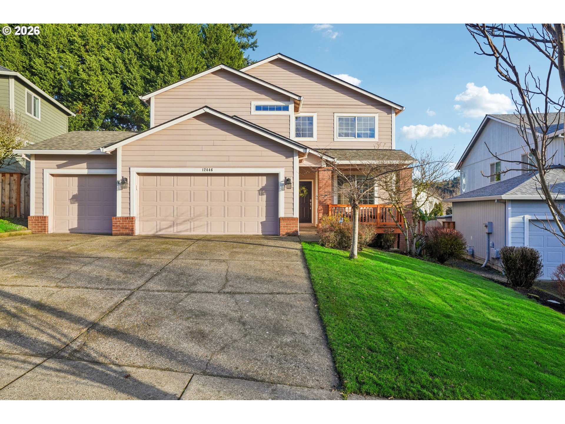 a front view of a house with a yard and garage