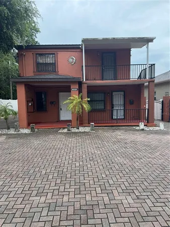 a view of a brick house with many windows