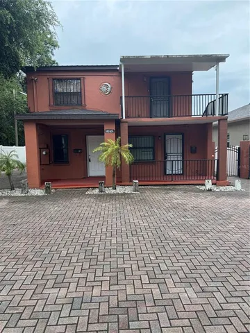 a view of a brick house with many windows