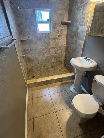 a bathroom with a sink a toilet and bathtub