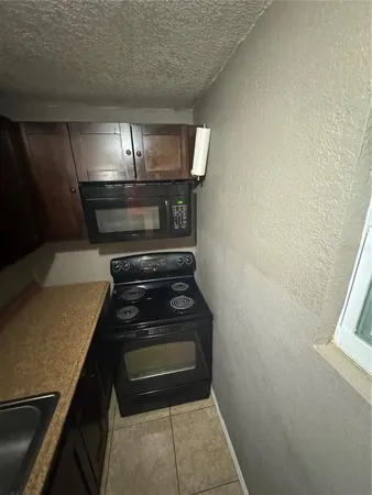 a stove top oven sitting inside of a kitchen