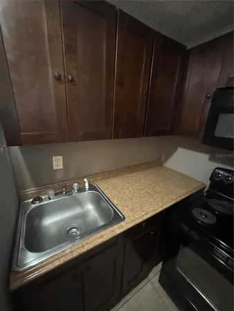 a kitchen with a sink cabinets and stove