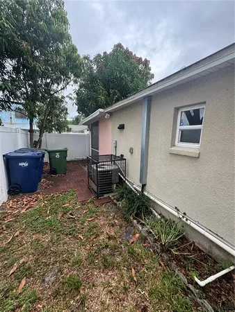 a backyard of a house with table and chairs