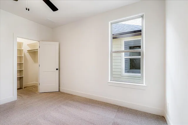 an empty room with windows and closet