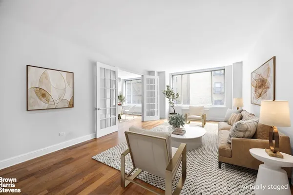 a dining room with furniture a window and wooden floor