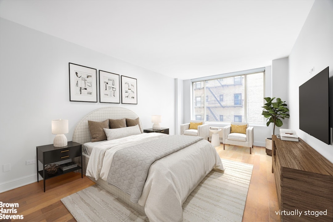 308 East 72nd Street, Unit 3D Manhattan, NY 10021 - Photo 7 of 8 a bedroom with a bed and a large window