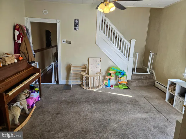 a view of living room with a baby crib